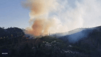 Aircraft Drops Pink Fire Retardant to Extinguish Burning Wildfire in Arizona