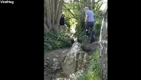 Man Trying to Jump Small Stream on Unicycle Prevai