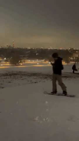 Snowboarder Takes to Snow-Covered Primrose Hill in Central London