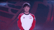 Sports gif. Esports player shoots a finger gun straight at us.