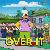 Sponsored gif. A giant slice of fruit pie falls onto Krusty the Klown, covering him in whipped cream while he stands looking annoyed. The Fortnite and Simpsons logos are in the upper right corner. Text reads: "Over it" 