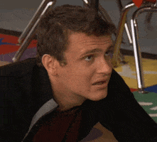 TV gif. Jason Segel looks a bit worried until he notices us, then smiles and winks.