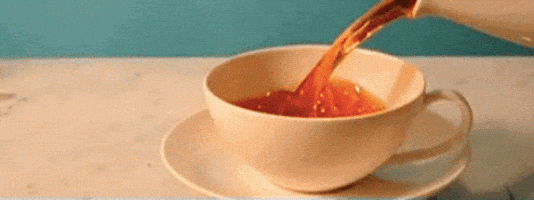 Video gif. A teacup on a saucer is filled with tea in slow motion.