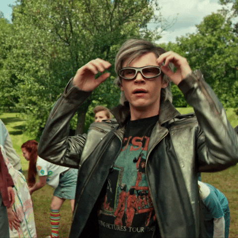 Movie gif. Evan Peters as Quicksilver in X-Men: Days of Future Past. He lands and quickly takes off his sunglasses to stare at something. He breathes heavily and looks shocked at the sight while saying, "Wow!"