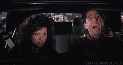 Seinfeld gif. Julia Louis-Dreyfus as Elaine with Jerry while he's driving, both of them laughing.
