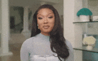 Celebrity gif. Megan Thee Stallion laughs as she tosses her hands over her shoulders. She points a bedazzled finger to the air with a wide smile. Text, "You know!"