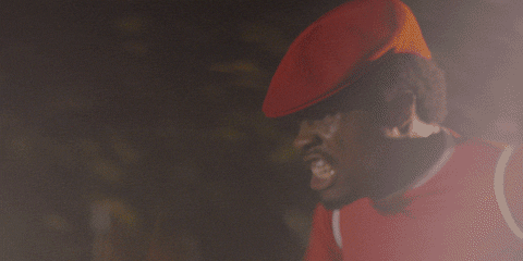 Movie gif. Shameik Moore as Curtis "Shaolin Fantastic" Caldwell from The Rundown furiously pumps his arms as he speeds down the road in a red cap.