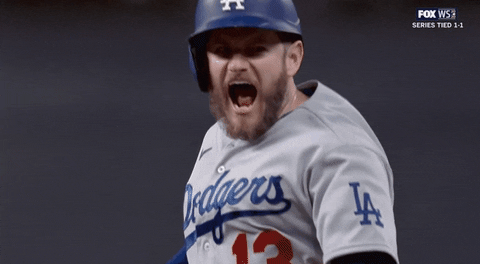 Sports gif. Los Angeles Dodgers player Max Muncy yells in triumph at the World Series.