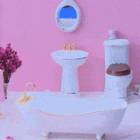 Sponsored gif. A hand places a gingerbread woman into a miniature bathtub. The cookie is wearing a turban and is wrapped in a towel with the Canada Dry logo. Text: "Holiday Homebody"