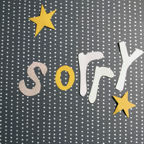 Text gif. The word "sorry" cycles through different scrapbook-like colors and textures on a background of contracting paper patterns.