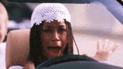 Movie gif. Behind the wheel of a car, Stacey Dash as Dionne in Clueless screams while letting go of the wheel.