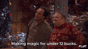 TV gif. Actor Jim Belushi in LIfe According to Jim admires his Christmas decor with his neighbor and contentedly says "Making magic for under 12 bucks!"