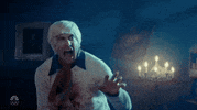 TV gif. Saturday Night Live guest host Jake Gyllenhaal as Fred in a sketch parodying Scooby-Doo. Gyllenhaal has blood on his white sweater as he bends over and pantomimes vomiting while looking at an unseen horrid sight in the distance. 