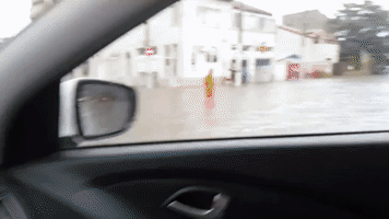Car Drives Through Knee-High Floodwaters After Storm Hits Constanta