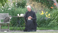 Cat Helps Itself to Some Milk During Dean of Canterbury's Morning Prayer