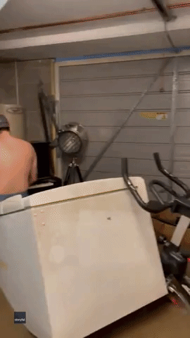 Man Plays Piano in Flooded Garage