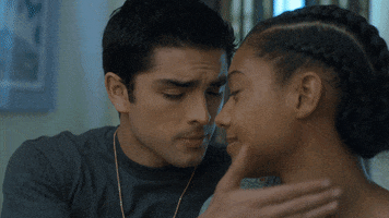 TV gif. From the show On My Block, Diego Tinoco and Sierra Capri as Cesar and Monse kiss, with Cesar's hand on Monse's neck.