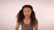 Celebrity gif. Shalita Grant looks at us then turns to the side and cups her hand around her mouth to shout "told ya!!!" and then looks back at us and nods knowingly.