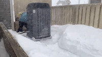 Residents Work to Keep Heat Pump Clear as Blizzard Blasts St John's