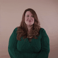 Reaction gif. A non-apparently Disabled white woman with with anxiety and depression and long red hair punctuates with a knowing wink.