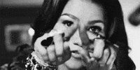 Celebrity gif. Zendaya draws a heart in the air with her hands. 