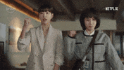 TV gif. Park Eun-bin as Young-woo and Ha Yoon-kyung as Su-yeon in Extraordinary Attorney Woo. Both of them are in the office reporting to a higher up and each of them pump a fist out in cheer and encouragement.