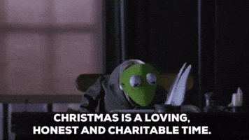 Cartoon gif. Kermit from The Muppet Christmas Carol. He sits at a desk in a suit and looks up while giving us a gentle smile and says, "Christmas is a loving, honest, and charitable time."