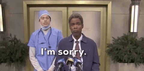 SNL gif. Chris Rock as a PR representative at a podium, face in quiet disbelief, as Pete Davidson, dressed as a scrubbed surgeon, stands behind him half-in-half-out of character, he shaking his head and saying "I'm sorry." 