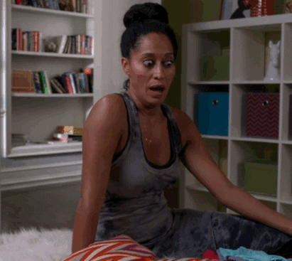 TV gif. Tracee Ellis Ross from Black-ish awkwardly sits on the edge of a bed, eyes wide. She raises her eyebrows and purses her lips dramatically as if to say “oops!”
