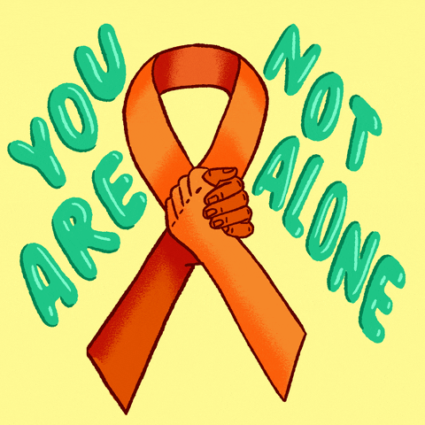 Text gif. Orange commemorative ribbon completed by two arms in a G-Lock handshake. Text, "You are not alone" against a light yellow background.