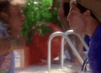 SNL gif. Adam Sandler and Chris Farley lean excitedly face to face with open mouths and thumbs up. 