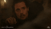 TV gif. Alexander Dreymon as Uhtred on The Last Kingdom rolls his eyes and looks away from someone with disappointment and boredom.