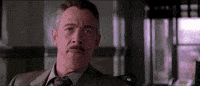 Movie gif. JK Simmons as Jonah and Tobey Maguire as Peter in Spider-Man. Jonah stares at Peter before laughing in his face, mocking and undermining him.