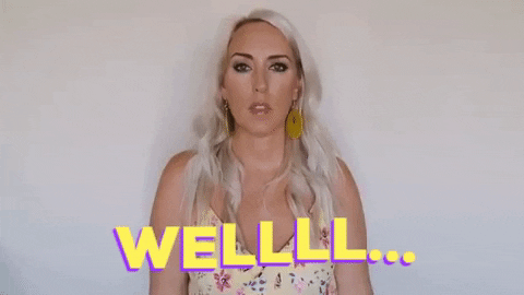Celebrity gif. Chelsie Kenyon shrugs at us against a white background. Text, A drawn-out "Well..."