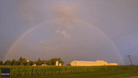 Lightning Flashes as Rainbow Arcs Through Minnesota Sky