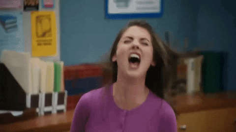 TV gif. Alison Brie as Annie in Community screams with rage in the study room, her mouth wide open and her eyebrows down, shaking her head and moving her shoulders back.