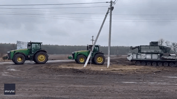 Ukrainian Farmer Tows Russian Military Tank