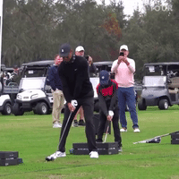 Tiger and Charlie Woods Swing Clubs in Sync 