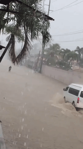 Children Play in Flooded Street as Typhoon Hits Philippines