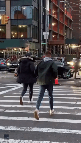 Passersby Rush to Help Lift SUV Off Woman in New York City Traffic Incident