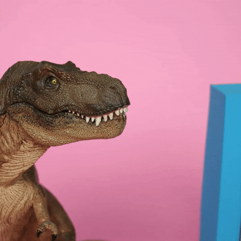 Stop-motion gif. A toy T-Rex opens its mouth and a yellow paper speech bubble appears, saying, "yeah!"