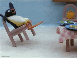 Sponsored gif. Pingu the claymation penguin tilts backward on the back two legs of his chair while looking shocked.