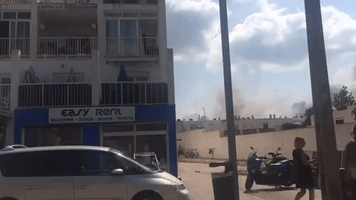 Tourists Watch as Firefighters Battle Fire in Ibiza's San Antonio
