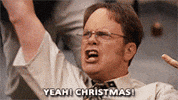 The Office gif. Rainn Wilson as Dwight Schrute pumps his fist into the air and yells, "Christmas!"