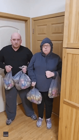 Couple Spread Easter Cheer at Apartment Building Facing Rent Rises