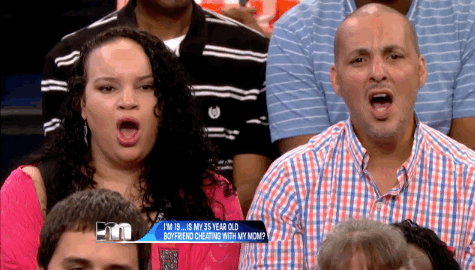 Reality TV gif. Two audience members on The Maury Show shake their heads, furrow their brows and gasp, yelling, “no!”