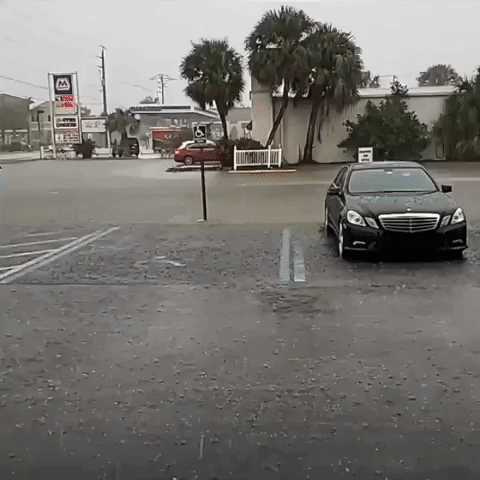 Cars Navigate Floodwaters During Heavy Rain in Southwest Florida