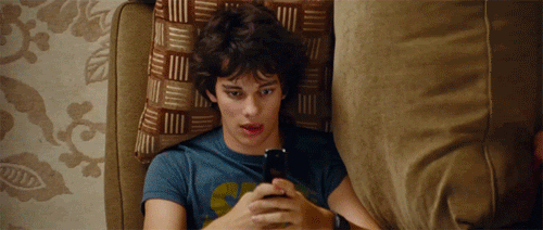 A man is using his phone, surrounded by images of other people also using their phones.