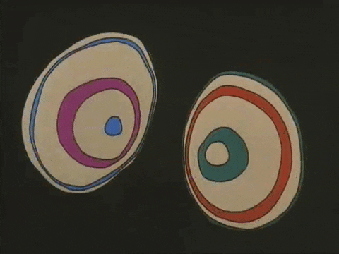 Cartoon gif. Two wide-open eyeballs with rapidly expanding and contracting rings of purple, blue, red, and green, from Fritz the Cat, against a black background.
