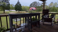Wind Blows Chair Across Porch in Southeast Arkansas as Stormy Weather Sweeps State